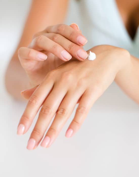 Applying body lotion on hand for skin benefits
