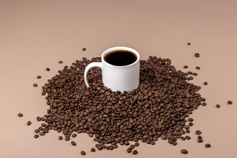 Coffee mug in a bean pile